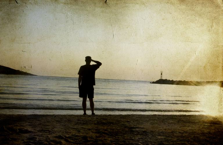 Man on beach watching a sunset