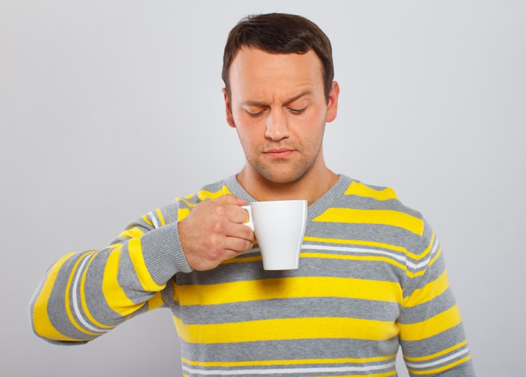 A man staring into a mug