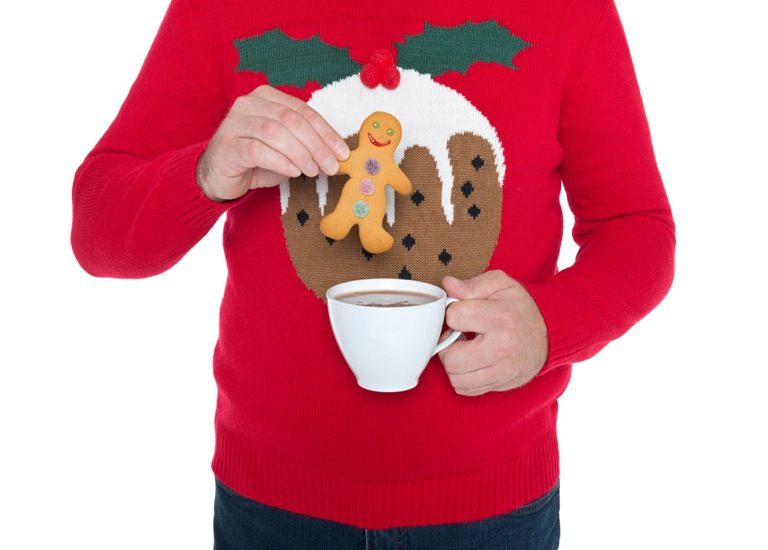 Man in Christmas jumper with tea