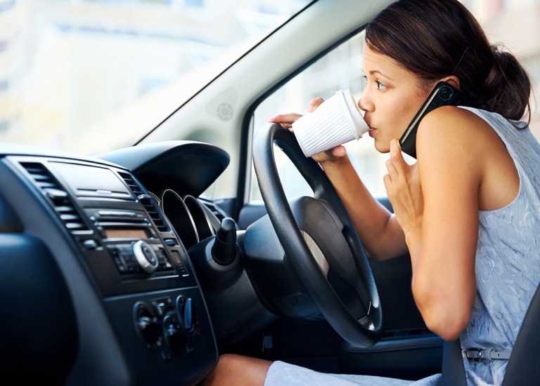 busy woman driving while on mobile