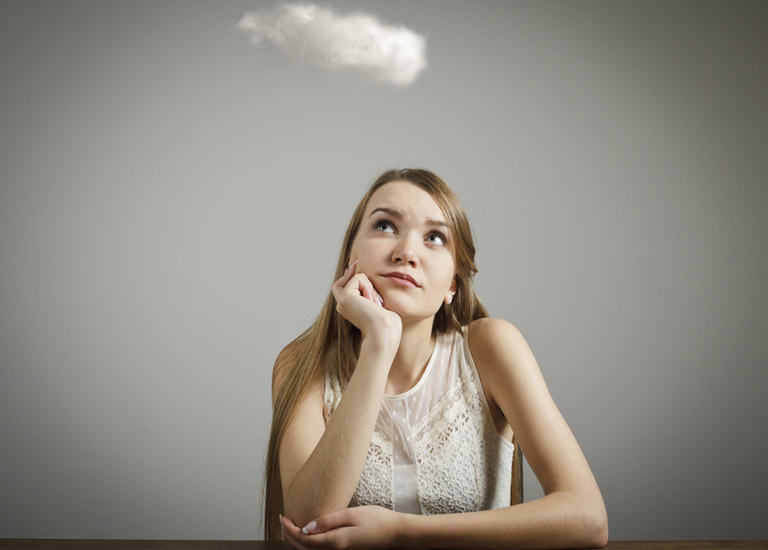 Girl thinking with a white cloud above her head