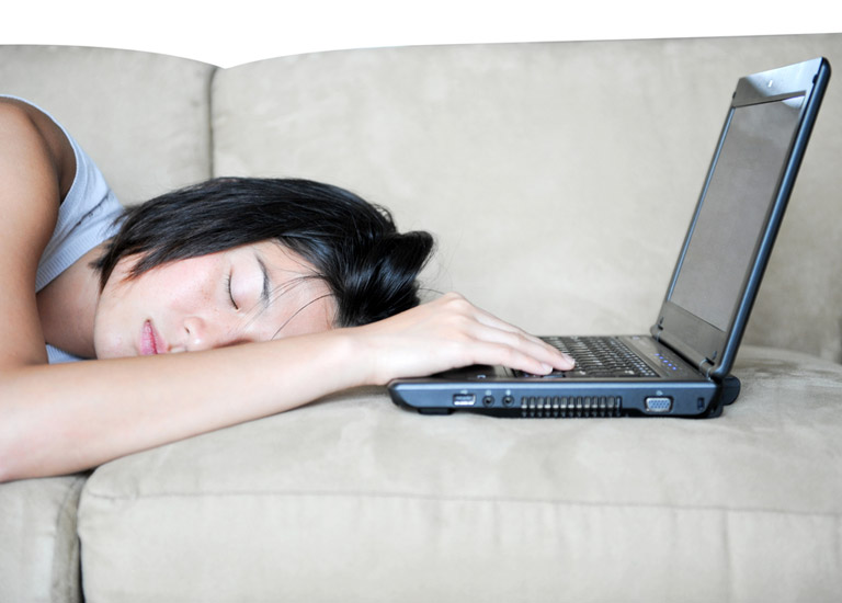 Woman asleep at a laptop