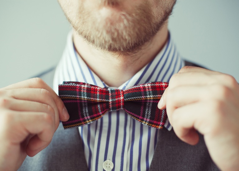 man fixing bow tie