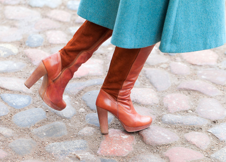 Woman walking along the pavement