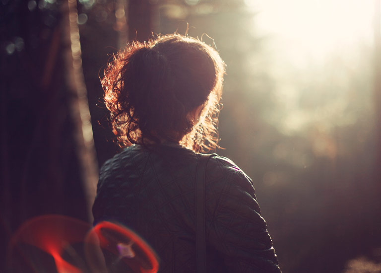 Girl thinking facing the sun