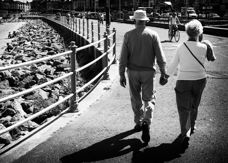 Elderly couple walking near beach