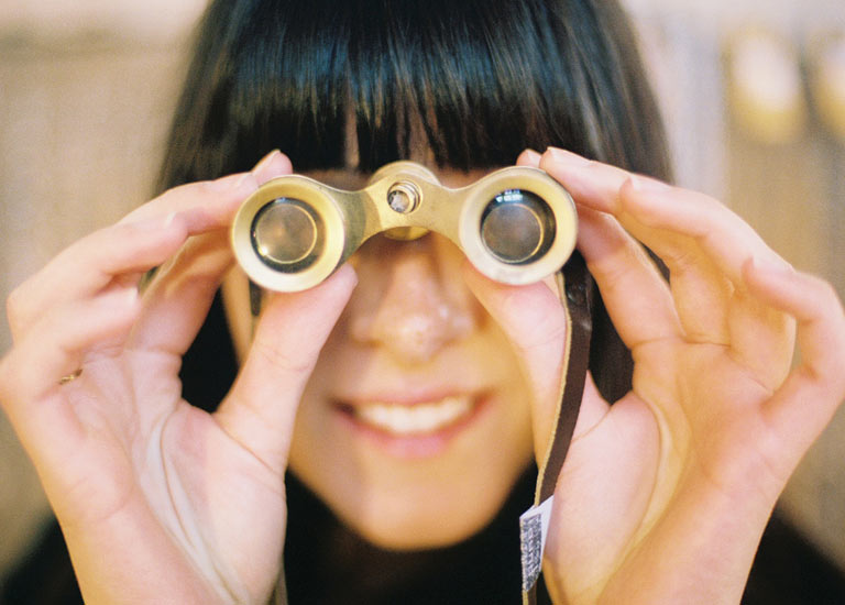 A woman looking through binoculars