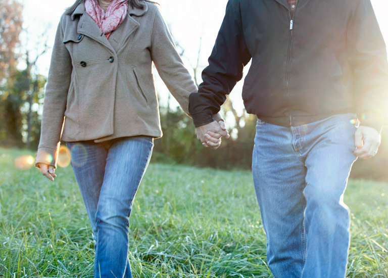 Older couple holding hands