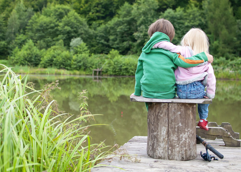 Young siblings hug