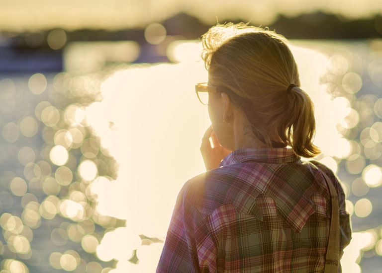 Woman looking out at a lake