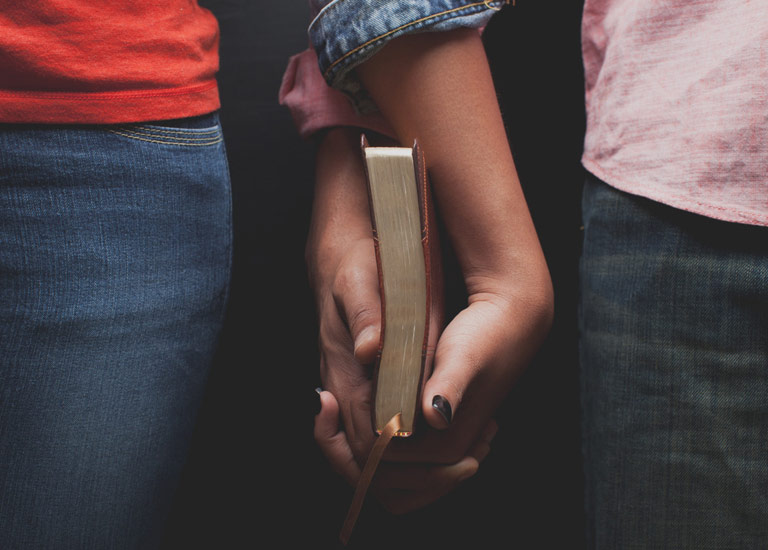 Couple holding a Bible together