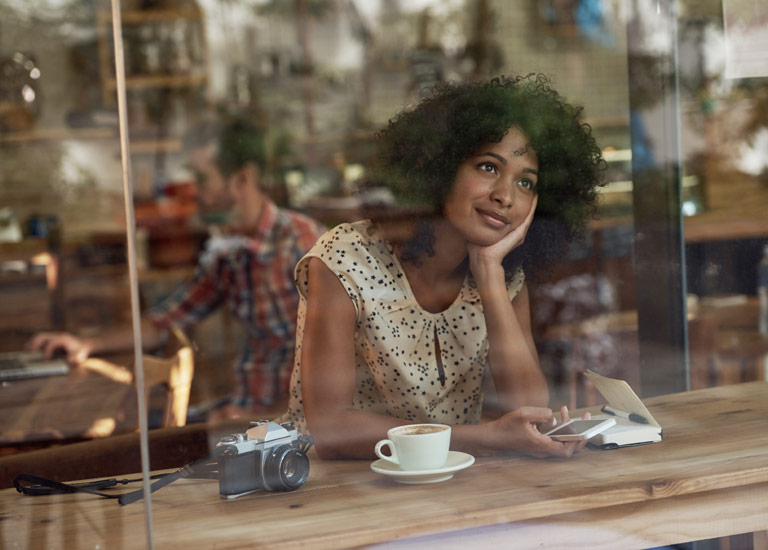 A woman looking out of the window daydreaming