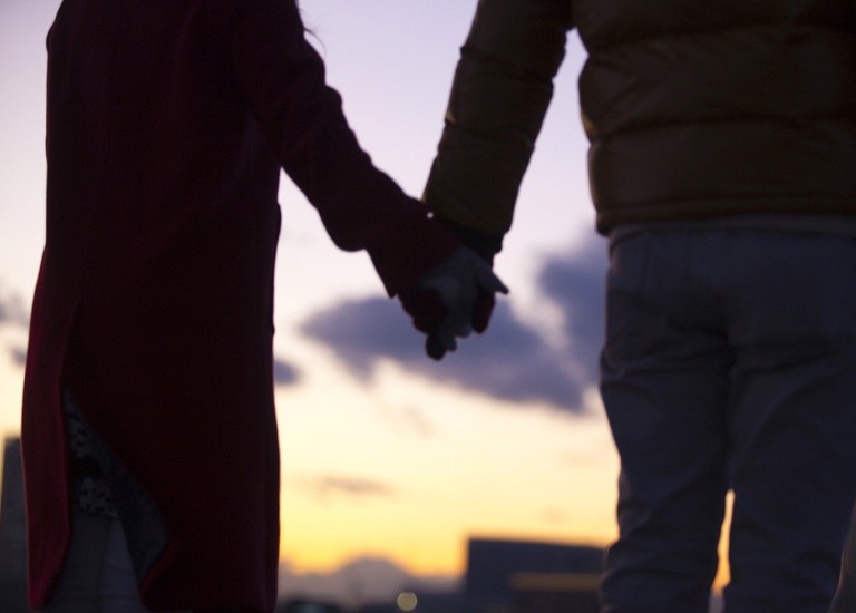 Couple in winter coats holding hands