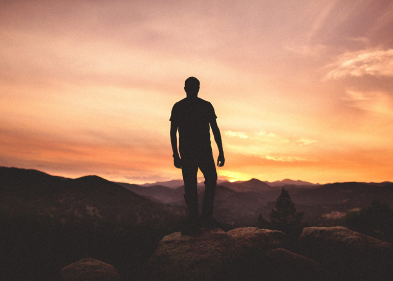 Silhouette of a man against a sunset