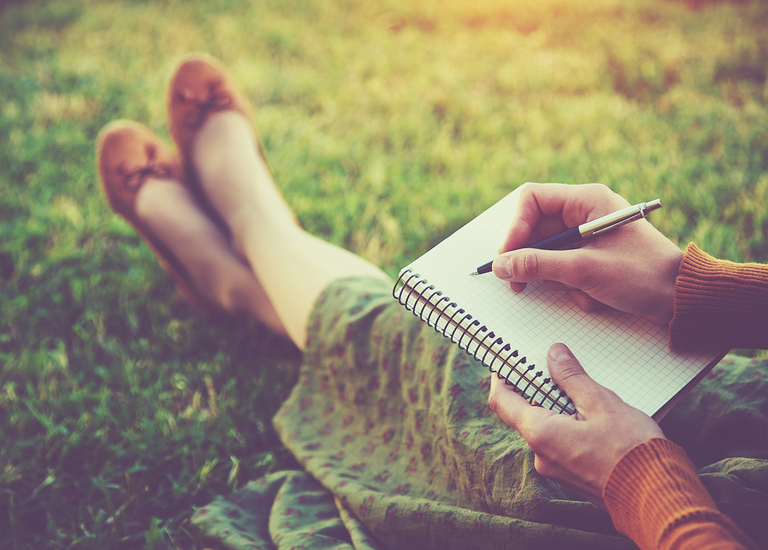 girl sitting writing letter