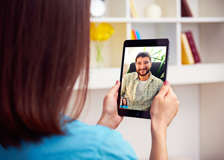 Man and woman talking via video chat