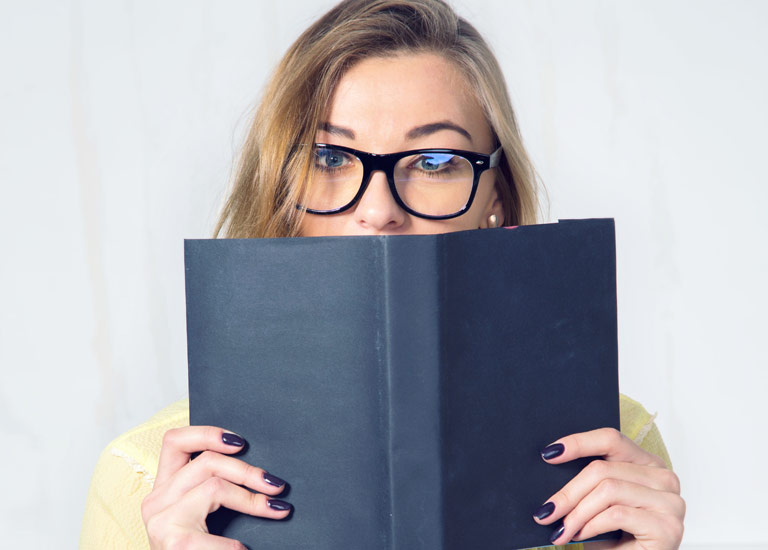 Woman holding diary in front of her face