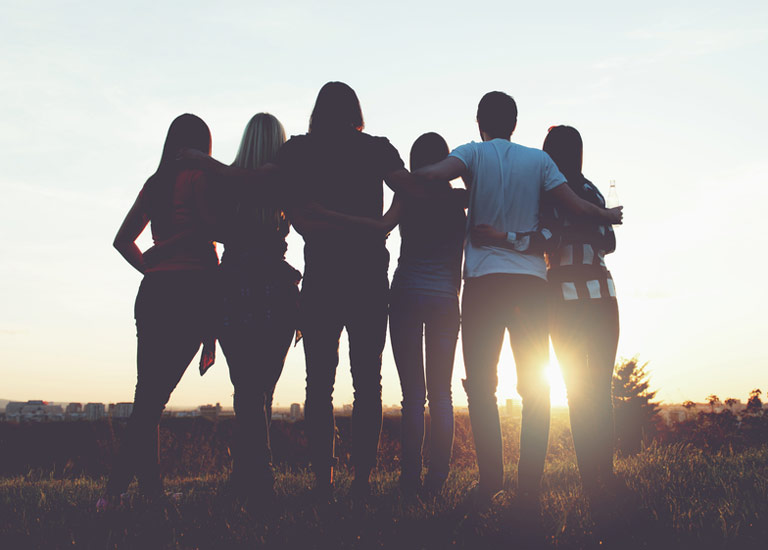 Group of friends watching a sunset