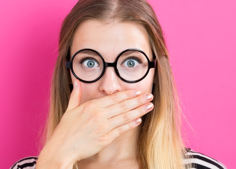 Woman with her hand over her mouth