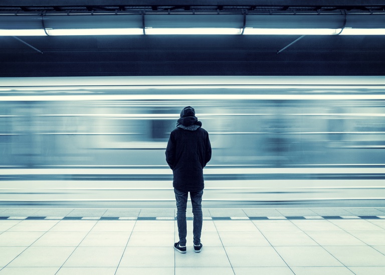 Man waiting on a train platform