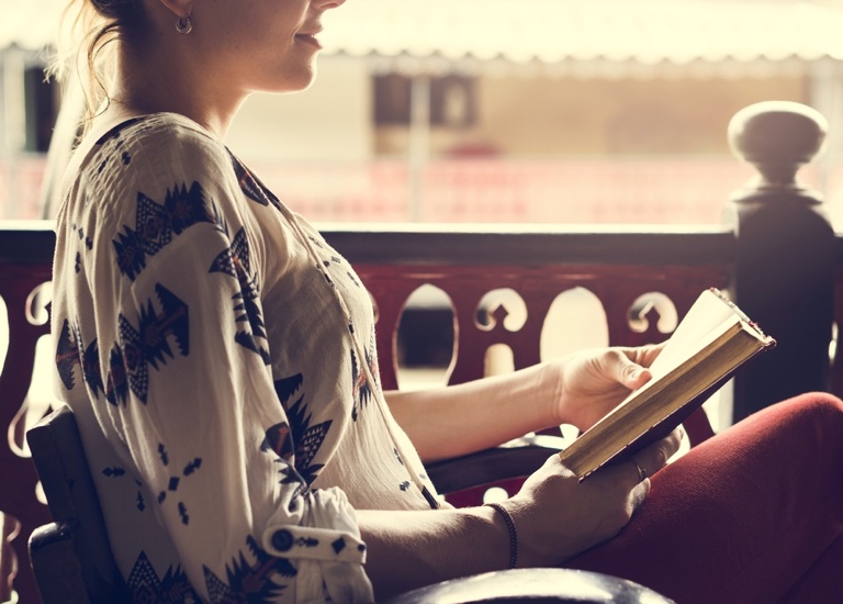 A woman sitting and reading