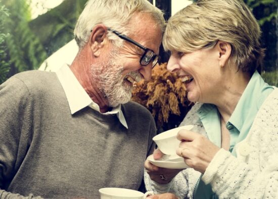 Senior couple drinking tea and laughing