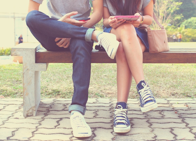 A couple both looking at their phones