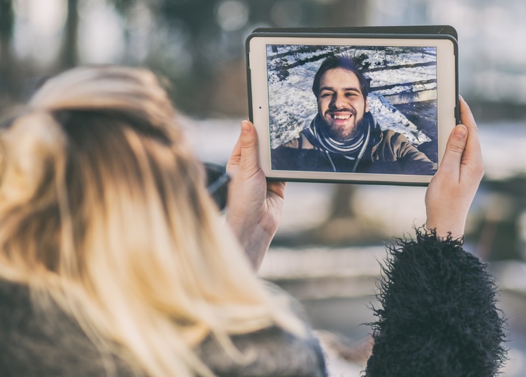 A couple video chatting on a tablet