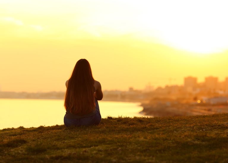 Woman sitting watching the sunset