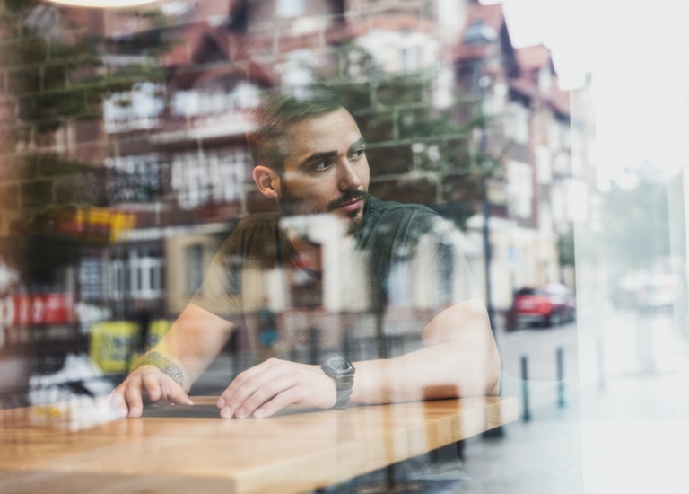 A man looking out of a cafe window