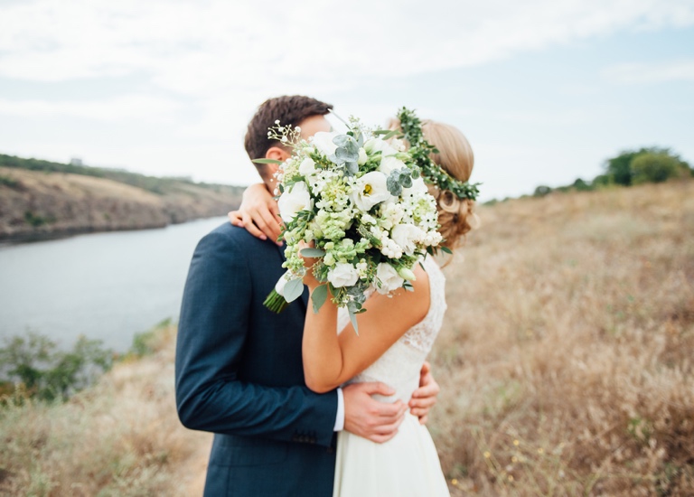 A couple embrace on their wedding day