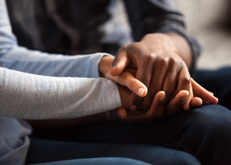 Holding hands together in support