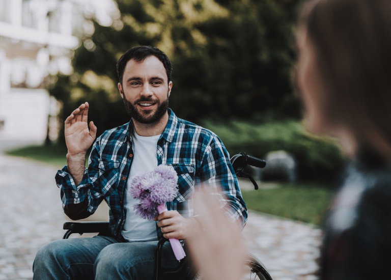 A man in a wheelchair meeting a woman