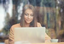 A young woman typing on a laptop