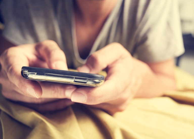 A closeup photo of someone messaging on a smartphone