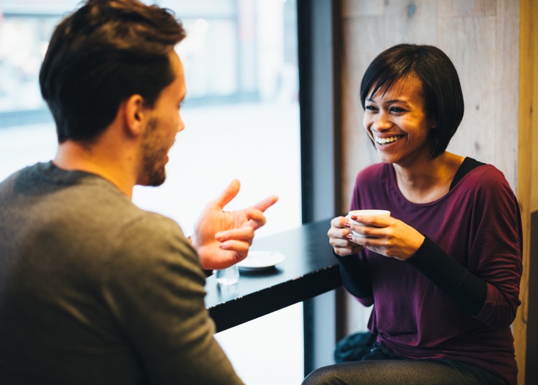 A man and a woman meet for coffee