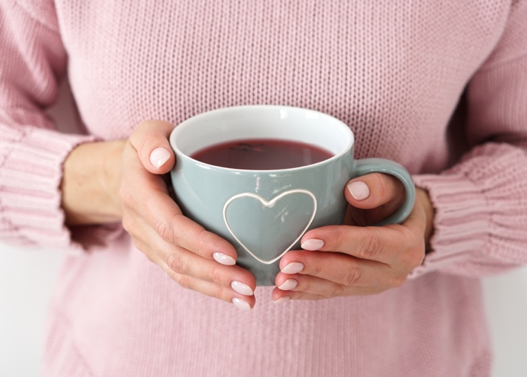 A woman holding a mug of tea