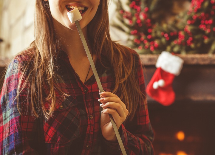 Single woman enjoys Christmas marshmallow