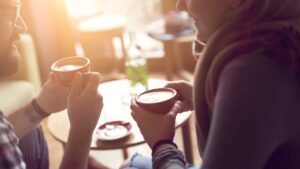 7 simple things to remember for a great first date - Christian Connection blog - Two people sitting in a cafe, drinking coffee and having a conversation