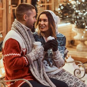 Man and woman enjoying drinks a Christmas market - Christian Connection blog - 6 joyful Christmas date ideas to celebrate the season