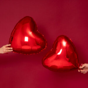 Hands holding heart balloons - 3 ways to make Valentine’s Day a catalyst for change - Christian Connection blog