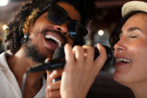 Couple singing karaoke - 8 fun extrovert date ideas - Christian Connection blog