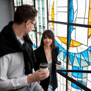 Couple in front of stained glass window - 3 important steps towards commitment in the early stages of a relationship - Christian Connection blog