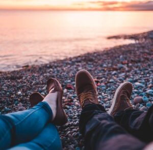 Two people's legs on a beach at sunrise - Why being authentic (and specific!) online leads to the best connections - Christian Connection blog